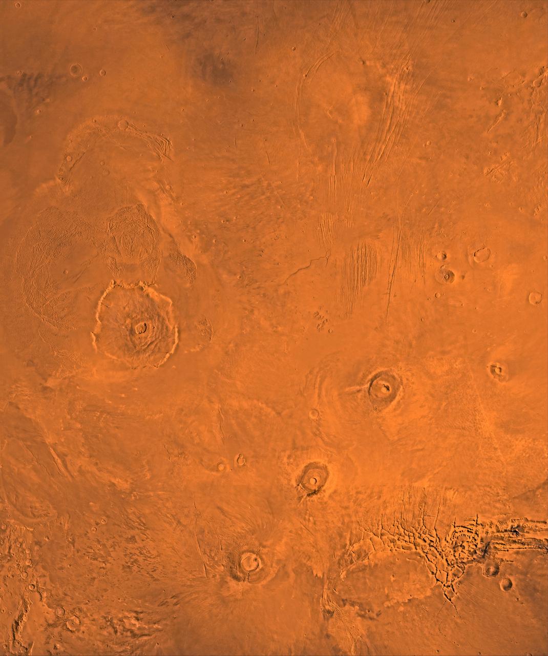 A color image of the Tharsis region of Mars; north toward top. The scene shows the Tharsis bulge, a huge ridge covered by the 3 large aligned Tharsis Montes shield volcanoes (from lower left to right): Arsia, Pavonis, and Ascraeus Mons. To the left of the Tharsis Montes lies the huge Olympus Mons shield volcano, followed clockwise by Alba Patera (north center), several smaller volcanoes, and the linear depressions of Mareotis and Tempe Fossae (upper right). This image is a composite of Viking medium-resolution images in black and white and low-resolution images in color. The image extends from latitude 50 degrees N. to 20 degrees S. and from longitude 85 degrees to 150 degrees. Mercator projection is used between latitudes 20 degrees S. and 30 degrees N.; Lambert projection is used above latitude 30 degrees N. The Tharsis bulge encompasses the most intensely and most recently active volcanic region of the planet. Each Tharsis Montes volcano is 350-400 km in diameter and about 17 km above the surrounding plain. The volcanoes are about 700 km apart and appear to be above a major northeast-trending fracture zone along the bulge, now buried by volcanic deposits. Olympus Mons (left center) is the largest known volcano in the Solar System. It is 27 km high, over 600 km at the base, and is surrounded by a well-defined scarp that is up to 6 km high. The summit calderas (central depressions) of all four volcanoes probably formed from recurrent collapse following drainage of magma resulting from flank eruptions. 1,600-km-diameter Alba Patera (north center) far exceeds any other known volcano in areal extent; it covers eight times the area of Olympus Mons but reaches only about 6 km in height. Fossae (linear depressions) of the Tharsis area are fault-bound graben formed by upwarping of the Tharsis bulge. http://photojournal.jpl.nasa.gov/catalog/PIA00408