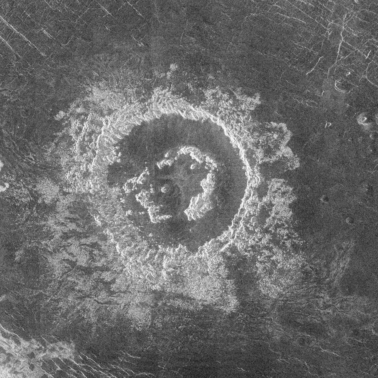 During orbits 404 through 414 on 19-20 September 1990, NASA's Magellan imaged a peak-ring crater that is 50 kilometers in diameter located at latitude 27.4 degrees north and longitude 337.5 degrees east. The name Barton has been proposed by the Magellan Science Team for this crater, after Clara Barton, founder of the Red Cross; however, the name is tentative pending approval by the International Astronomical Union.      Barton is just at the diameter size that Venus craters appear to begin to possess peak-rings instead of a single central peak or central peak complex like does 75 percent of the craters with diameters between 50 and about 15 kilometers. The floor of the crater is flat and radar-dark, indicating possible infilling by volcanic deposits sometime following the impact event. Barton's central peak ring is discontinuous and appears to have been disrupted or separated during or following the cratering process. The extremely blocky crater deposits (ejecta) surrounding Barton appear to be most extensive on the southwest to southeast (lower left to right) side of the crater.   http://photojournal.jpl.nasa.gov/catalog/PIA00463