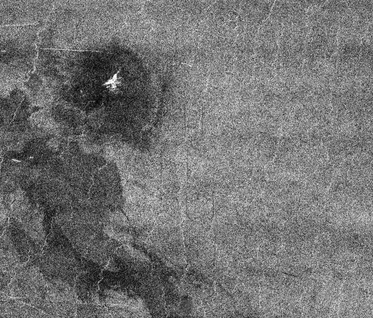 This full resolution mosaiced image covers an area of approximately 100 kilometers by 120 kilometers (62 by 74 miles) and is located in the Lakshmi region of Venus at 47 degrees north latitude and 334 east longitude. Due to the dense Venusian atmosphere, primary impact craters of less than a 3 kilometer (2 mile) diameter are nonexistent. The dark circular region and associated central bright feature in this image are thought to be the remnants of a meteoroid smaller than the size necessary to create an impact crater entering the atmosphere at a low velocity (approximately 350 meters/second.) The central bright feature appears to be a cluster of small secondary impacts, ejecta and debris from the original meteor that broke up in the atmosphere. Even though most of the meteorite did not hit the surface, the atmospheric shock wave could be great enough to modify the surrounding region. One explanation for this radar dark circular formation, called dark margins, could be that the shock wave was energetic enough to pulverize the surface (smooth surfaces generally appear radar dark.) Another explanation is that the surface could be blanketed by a fine material that was formed by the original meteor's breakup through the atmosphere. More than half of the impact craters on Venus have associated dark margins, and most of these are prominently located left of center of the crater. This is another effect which could be caused by the dense atmosphere of Venus.   http://photojournal.jpl.nasa.gov/catalog/PIA00477