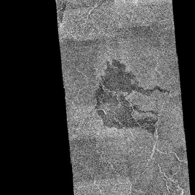 This image from NASA Magellan spacecraft shows an area of dark volcanic lava flows overlying the brighter surrounding plains which are thought to have been formed from older flows.