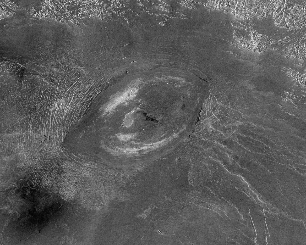 This image from NASA Magellan spacecraft reveals Sacajawea Patera, a large, elongate caldera located in Western Ishtar Terra on the smooth plateau of Lakshmi Planum.