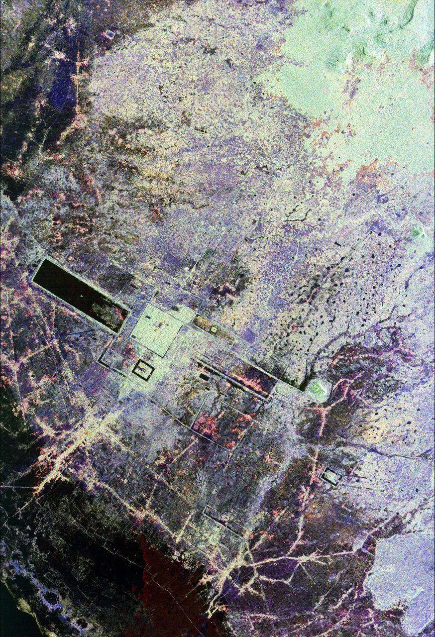 This is an image of the area around the city of Angkor, Cambodia. The city houses an ancient complex of more than 60 temples dating back to the 9th century. The principal complex, Angkor Wat, is the bright square just left of the center of the image. It is surrounded by a reservoir that appears in this image as a thick black line. The larger bright square above Angkor Wat is another temple complex called Angkor Thom. Archeologists studying this image believe the blue-purple area slightly north of Angkor Thom may be previously undiscovered structures. In the lower right is a bright rectangle surrounded by a dark reservoir, which houses the temple complex Chau Srei Vibol. In its heyday, Angkor had a population of 1 million residents and was the spiritual center for the Khmer people until it was abandoned in the 15th century. The image was acquired by the Spaceborne Imaging Radar-C/X-band Synthetic Aperture Radar (SIR-C/X-SAR) on the 15th orbit of the space shuttle Endeavour on September 30, 1994. The image shows an area approximately 55 kilometers by 85 kilometers (34 miles by 53 miles) that is centered at 13.43 degrees north latitude and 103.9 degrees east longitude. The colors in this image were obtained using the following radar channels: red represents the L-band (horizontally transmitted and received); green represents the L-band (horizontally transmitted and vertically received); blue represents the C-band (horizontally transmitted and vertically received). The body of water in the south-southwest corner is Tonle Sap, Cambodia's great central lake. The urban area at the lower left of the image is the present-day town of Siem Reap. The adjoining lines are both modern and ancient roads and the remains of Angkor's vast canal system that was used for both irrigation and transportation. The large black rectangles are ancient reservoirs. Today the Angkor complex is hidden beneath a dense rainforest canopy, making it difficult for researchers on the ground to study the ancient city. The SIR-C/X-SAR data are being used by archaeologists at the World Monuments Fund and the Royal Angkor Foundation to understand how the city grew, flourished and later fell into disuse over an 800-year period. The data are also being used to help reconstruct the vast system of hydrological works, canals and reservoirs, which have gone out of use over time. Research teams from more than 11 countries will be using this data to study the Angkor complex.  http://photojournal.jpl.nasa.gov/catalog/PIA00505