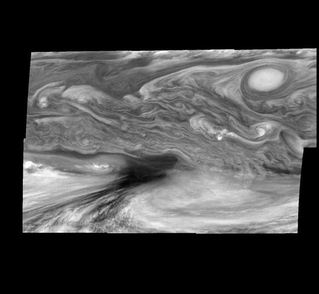 This photographic mosaic of images from NASA's Galileo spacecraft covers an area of 34,000 kilometers by 22,000 kilometers (about 21,100 by 13,600 miles) in Jupiter's equatorial region. The dark region near the center of the mosaic is an equatorial "hotspot" similar to the site where the Galileo Probe parachuted into Jupiter's atmosphere in December 1995. These features are holes in the bright, reflective, equatorial cloud layer where heat from Jupiter's deep atmosphere can pass through. The circulation patterns observed here along with the composition measurements from the Galileo Probe suggest that dry air may be converging and sinking over these regions, maintaining their cloud-free appearance. The bright oval in the upper right of the mosaic as well as the other smaller bright features are examples of upwelling of moist air and condensation. These images were taken on December 17, 1996, at a range of 1.5 million kilometers (about 930,000 miles) by the Solid State Imaging camera system aboard Galileo. North is at the top. The mosaic covers latitudes 1 to 19 degrees and is centered at longitude 336 degrees west. The smallest resolved features are tens of kilometers in size. http://photojournal.jpl.nasa.gov/catalog/PIA00604