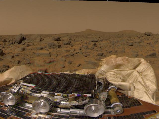 This is one of the first pictures taken by the camera on the Mars Pathfinder lander shortly after its touchdown at 10:07 AM Pacific Daylight Time on July 4, 1997. The small rover, named Sojourner, is seen in the foreground in its position on a solar panel of the lander. The white material on either side of the rover is part of the deflated airbag system used to absorb the shock of the landing. Between the rover and the horizon is the rock-strewn martian surface. Two hills are seen in the right distance, profiled against the light brown sky.  http://photojournal.jpl.nasa.gov/catalog/PIA00611