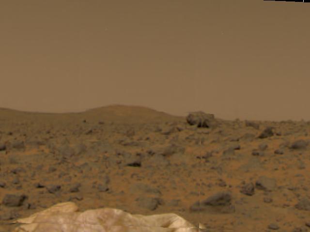 Portions of Mars Pathfinder's deflated airbags (seen in the foreground), a large rock in mid-field, and a hill in the background were taken by the Imager for Mars Pathfinder (IMP) aboard Mars Pathfinder during the spacecraft's first day on the Red Planet. Pathfinder successfully landed on Mars at 10:07 a.m. PDT earlier today.  The IMP is a stereo imaging system with color capability provided by 24 selectable filters -- twelve filters per "eye." It stands 1.8 meters above the Martian surface, and has a resolution of two millimeters at a range of two meters.  http://photojournal.jpl.nasa.gov/catalog/PIA00615