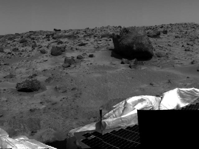 Several possible targets of study for rover Sojourner's Alpha Proton X-Ray Spectrometer (APXS) instrument are seen in this image, taken by the Imager for Mars Pathfinder (IMP) on Sol 2. The smaller rock at left has been dubbed "Barnacle Bill," while the larger rock at right, approximately 3-4 meters from the lander, is now nicknamed "Yogi." Barnacle Bill is scheduled to be the first object of study for the APXS. Portions of a petal and deflated airbag are also visible at lower right.  http://photojournal.jpl.nasa.gov/catalog/PIA00629
