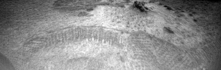 Tracks made by the Sojourner rover are visible in this image, taken by one of the cameras aboard Sojourner on Sol 3. The tracks represent the rover maneuvering towards the rock dubbed "Barnacle Bill." The rover, having exited the lander via the rear ramp, first traveled towards the right portion of the image, and then moved forward towards the left where Barnacle Bill sits. The fact that the rover was making defined tracks indicates that the soil is made up of particles on a micron scale.  http://photojournal.jpl.nasa.gov/catalog/PIA00633