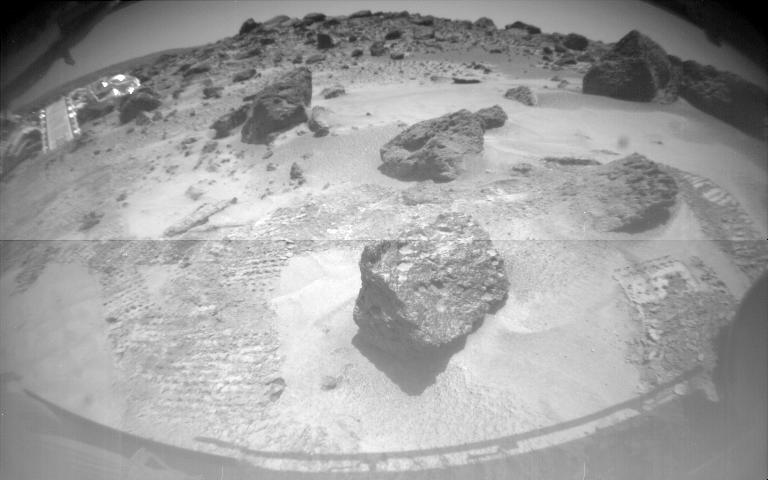 One of Sojourner's two front cameras took this image of the Sagan Memorial Station on Sol 6. The lander and its deployed rear ramp are at upper left, while several large rocks appear at center. Sojourner was near the large rock Yogi when this image was taken. Sojourner spent 83 days of a planned seven-day mission exploring the Martian terrain, acquiring images, and taking chemical, atmospheric and other measurements. The final data transmission received from Pathfinder was at 10:23 UTC on September 27, 1997. Although mission managers tried to restore full communications during the following five months, the successful mission was terminated on March 10, 1998.  http://photojournal.jpl.nasa.gov/catalog/PIA00673