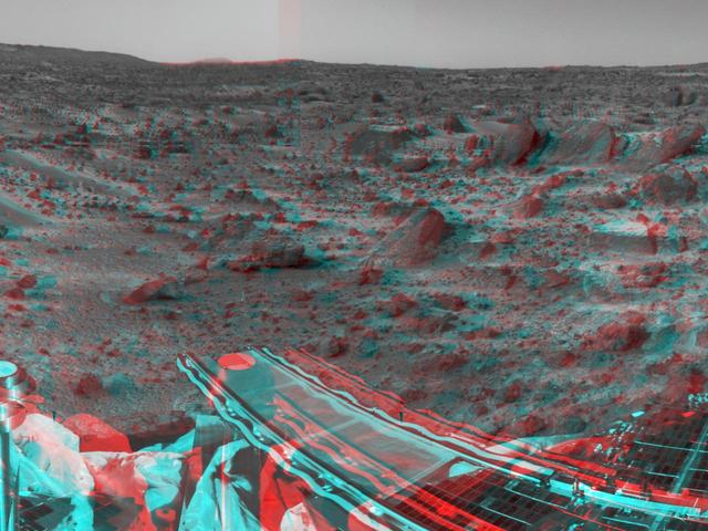 NASA Mars Pathfinder forward rover ramp can be seen successfully unfurled in this image, taken in stereo by the Imager camera. 3-D glasses are necessary to identify surface detail.