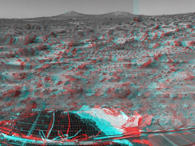 The two hills in the distance in this stereo image from NASA Mars Pathfinder have been dubbed the Twin Peaks. 3D glasses are necessary to identify surface detail.   