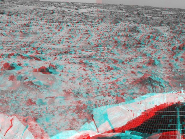 Portions of the lander deflated airbags and a petal are at lower left in this image from NASA Mars Pathfinder. 3D glasses are necessary to identify surface detail. 