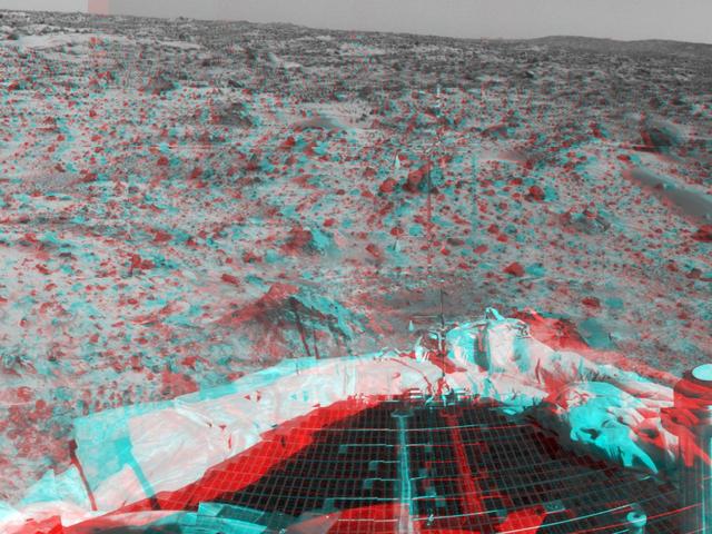 Portions of the lander deflated airbags and a petal are at lower left in this image from NASA Mars Pathfinder. 3D glasses are necessary to identify surface detail. 