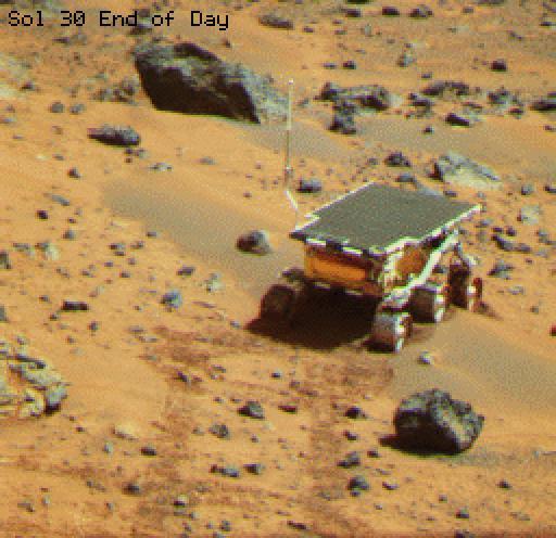 This is an image of the rover Sojourner at the feature called Mermaid Dune at the MPF landing site. Mermaid is thought to be a low, transverse dune ridge, with its long (approximately 2 meters) axis transverse to the wind, which is thought to come from the lower left of the image and blow toward the upper right. The rover is facing to the lower left, the "upwind" direction. The rover's middle wheels are at the crestline of the small dune, and the rear wheels are on the lee side of the feature. A soil mechanics experiment was performed to dig into the dune and examine the sediments exposed.  http://photojournal.jpl.nasa.gov/catalog/PIA00794