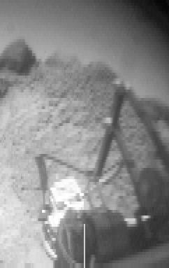 This image of the rock "Wedge" was taken from the Sojourner rover's rear color camera on Sol 37. The position of the rover relative to Wedge is seen in MRPS 83349. The segmented rod visible in the middle of the frame is the deployment arm for the Alpha Proton X-Ray Spectrometer (APXS). The APXS, the bright, cylindrical object at the end of the arm, is positioned against Wedge and is designed to measure the rock's chemical composition. This was done successfully on the night of Sol 37. http://photojournal.jpl.nasa.gov/catalog/PIA00906