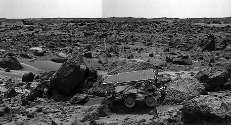 The Sojourner rover's Alpha Proton X-ray Spectrometer (APXS) is shown deployed against the rock "Moe" on the afternoon of Sol 64 (September 7). The rocks to the left of Moe are "Shark" (left of Sojourner) and "Half Dome" (behind Sojourner). They were previously measured by the APXS. The image was taken by the Imager for Mars Pathfinder (IMP). http://photojournal.jpl.nasa.gov/catalog/PIA00966
