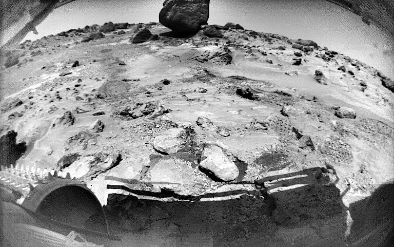This Sojourner image, taken on Sol 70, shows rocks and rover-disturbed soil. Cleats on Sojourner's left front wheel are seen at lower left. The large rock in the distance is "Yogi." Much of Yogi visible in this image cannot be seen from the perspective of the Pathfinder lander. Sojourner spent 83 days of a planned seven-day mission exploring the Martian terrain, acquiring images, and taking chemical, atmospheric and other measurements. The final data transmission received from Pathfinder was at 10:23 UTC on September 27, 1997. Although mission managers tried to restore full communications during the following five months, the successful mission was terminated on March 10, 1998. http://photojournal.jpl.nasa.gov/catalog/PIA00998