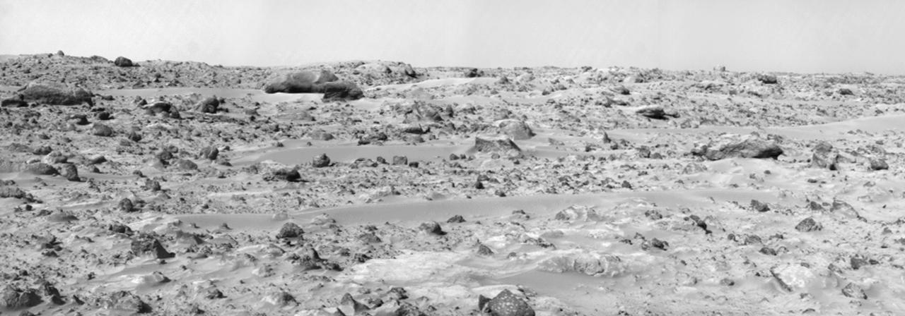 This panorama of the region to the northeast of the lander was constructed to support the Sojourner Rover Team's plans to conduct an "autonomous traverse" to explore the terrain away from the lander after science objectives in the lander vicinity had been met. The large, relatively bright surface in the foreground, about 10 meters (33 feet) from the spacecraft, in this scene is "Baker's Bench." The large, elongated rock left of center in the middle distance is "Zaphod."  This view was produced by combining 8 individual "Superpan" scenes from the left and right eyes of the IMP camera. Each frame consists of 8 individual frames (left eye) and 7 frames (right eye) taken with different color filters that were enlarged by 500% and then co-added using Adobe Photoshop to produce, in effect, a super-resolution panchromatic frame that is sharper than an individual frame would be.  http://photojournal.jpl.nasa.gov/catalog/PIA01000
