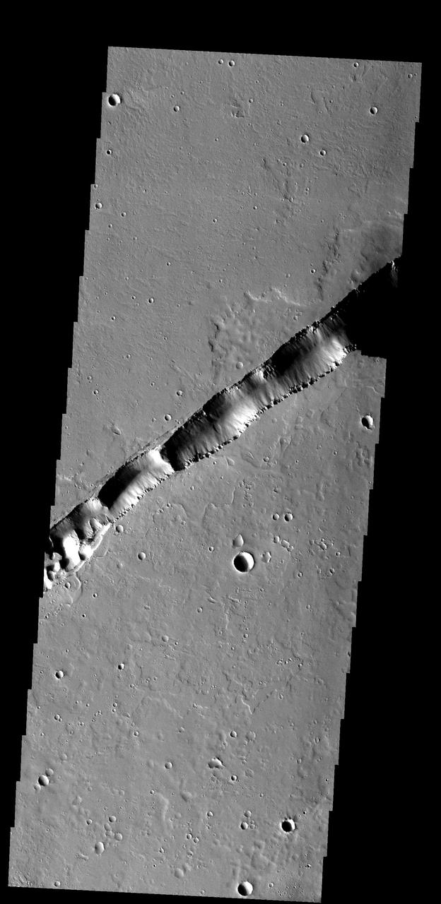 This large fracture occurs on the lava flows of Ceraunius Tholus.