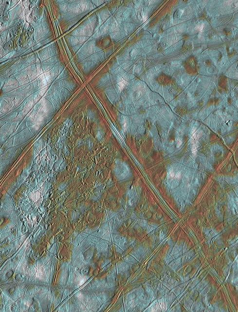 This image of Jupiter icy satellite Europa shows surface features such as domes and ridges, as well as a region of disrupted terrain including crustal plates which are thought to have broken apart and rafted into new positions.