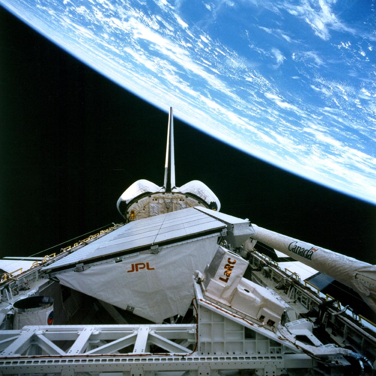 NASA SIR-C/X-SAR is shown here in the payload bay of the orbiting space shuttle Endeavour STS-59, with an area of the Pacific Ocean northeast of Hawaii in the background.