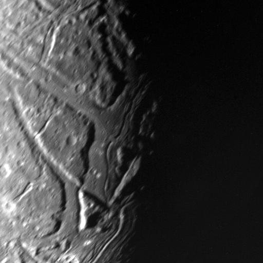 This NASA Voyager 2 view of Uranus moon Ariel terminator shows a complex array of transecting valleys with super-imposed impact craters. 