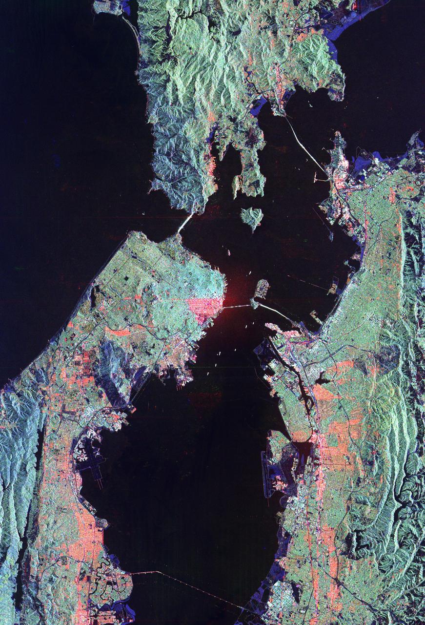 This image of San Francisco, California shows how the radar distinguishes between densely populated urban areas and nearby areas that are relatively unsettled. Downtown San Francisco is at the center and the city of Oakland is at the right across the San Francisco Bay. Some city areas, such as the South of Market, called the SOMA district in San Francisco, appear bright red due to the alignment of streets and buildings to the incoming radar beam. Various bridges in the area are also visible including the Golden Gate Bridge (left center) at the opening of San Francisco Bay, the Bay Bridge (right center) connecting San Francisco and Oakland, and the San Mateo Bridge (bottom center). All the dark areas on the image are relatively smooth water: the Pacific Ocean to the left, San Francisco Bay in the center, and various reservoirs. Two major faults bounding the San Francisco-Oakland urban areas are visible on this image. The San Andreas fault, on the San Francisco peninsula, is seen in the lower left of the image. The fault trace is the straight feature filled with linear reservoirs which appear dark. The Hayward fault is the straight feature on the right side of the image between the urban areas and the hillier terrain to the east. The image is about 42 kilometers by 58 kilometers (26 miles by 36 miles) with north toward the upper right. This area is centered at 37.83 degrees north latitude, 122.38 degrees east longitude.   http://photojournal.jpl.nasa.gov/catalog/PIA01791