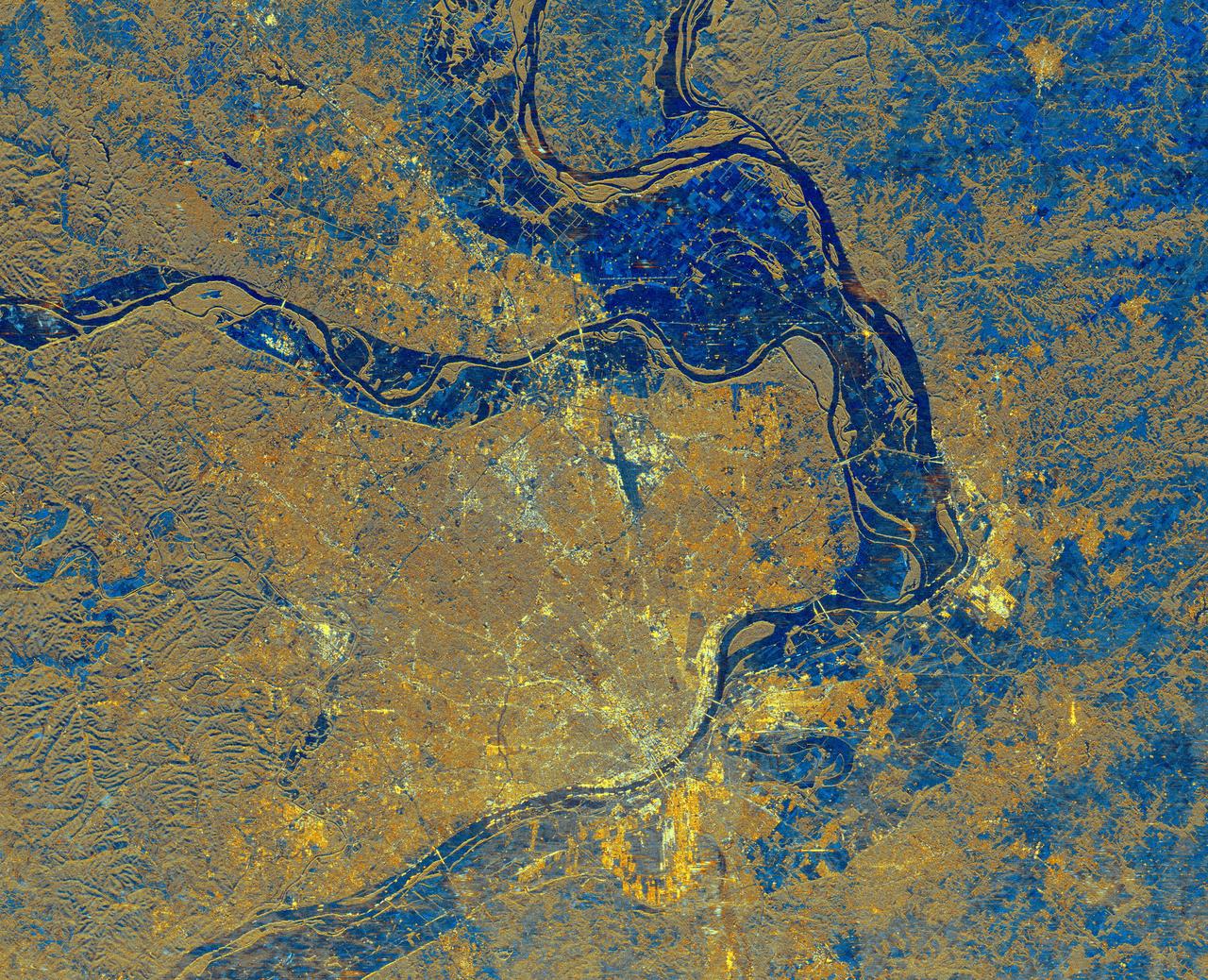 This is a spaceborne radar image of the area surrounding St. Louis, Missouri, where the Mississippi and Missouri Rivers come together. The city of St. Louis is the bright gold area within a bend in the Mississippi River at the lower center of the image.