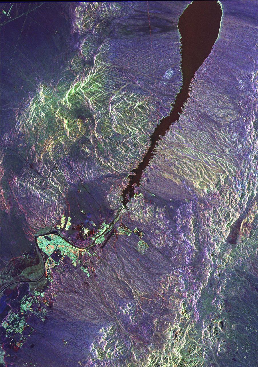 This space radar image illustrates the recent rapid urban development occurring along the lower Colorado River at the Nevada/Arizona state line. Lake Mojave is the dark feature that occupies the river valley in the upper half of the image.