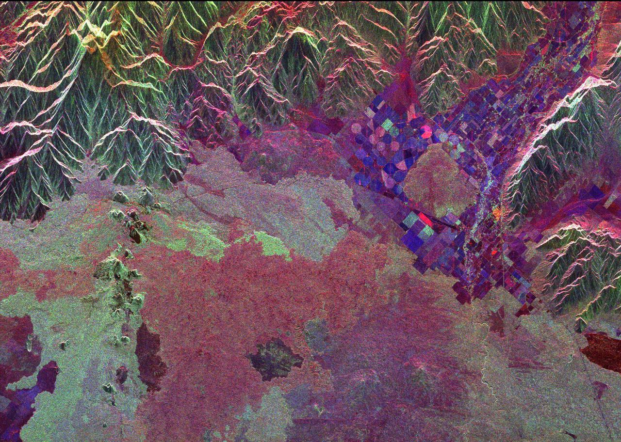 Ancient lava flows dating back 2,000 to 15,000 years are shown in light green and red on the left side of this space radar image of the Craters of the Moon National Monument area in Idaho.