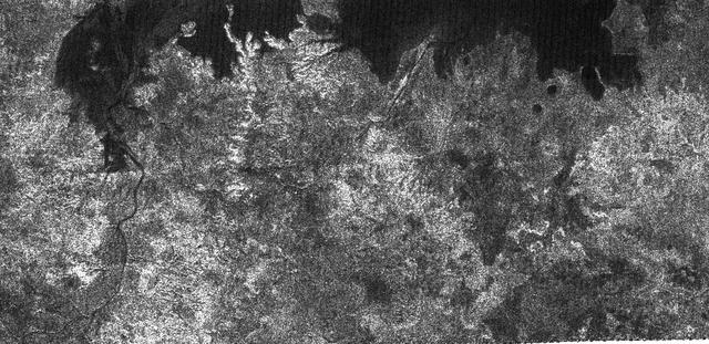 The large dark patch seen on this image at high latitudes surrounding Titan north pole, is from NASA Cassini spacecraft radar system, and most likely a hydrocarbon lake.