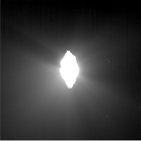 This image shows the view from NASA Deep Impact probe 30 minutes before it was pummeled by comet Tempel 1. The picture brightness has been enhanced to show the jets of dust streaming away from the comet.