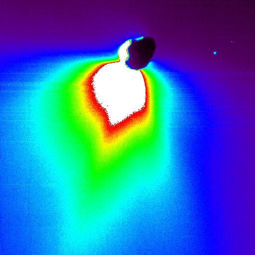 This false-color image shows comet Tempel 1 about 50 minutes after NASA Deep Impact probe smashed into its surface. The impact site is located on the far side of the comet in this view.