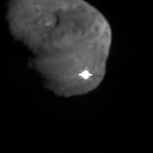The image depicts the first moments after NASA Deep Impact probe interfaced with comet Tempel 1. The illuminated, and possibly incandescent, debris is expanding from the impact site.