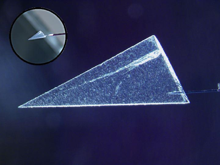 This image illustrates one of several ways scientists have begun extracting comet particles from NASAa Stardust spacecraft collector. First, a particle and its track are cut out of the collector material, called aerogel.