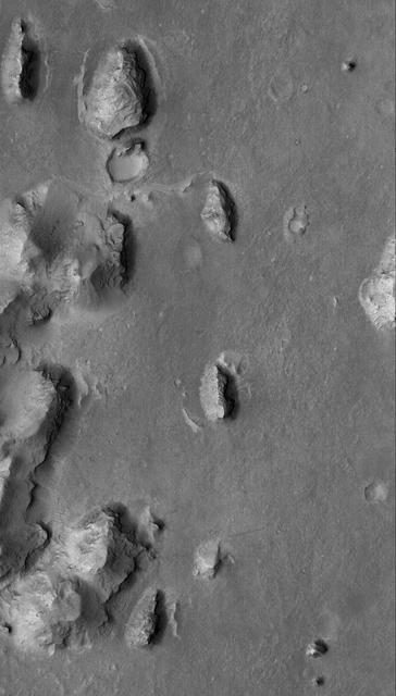This Mars Global Surveyor MGS Mars Orbiter Camera MOC image shows layered buttes, knobs, and other landforms exposed by erosion in the Aeolis region of Mars