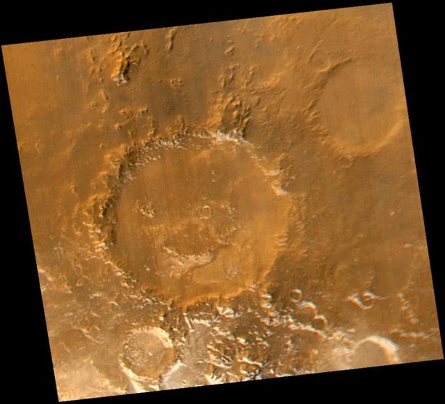 Smile! Spring has sprung in the martian southern hemisphere. With it comes the annual retreat of the winter polar frost cap. This view of "Happy Face Crater"--officially named "Galle Crater"--shows patches of white water ice frost in and around the crater's south-facing slopes. Slopes that face south will retain frost longer than north-facing slopes because they do not receive as much sunlight in early spring. This picture is a composite of images taken by the Mars Global Surveyor Mars Orbiter Camera (MOC) red and blue wide angle cameras. The wide angle cameras were designed to monitor the changing weather, frost, and wind patterns on Mars. Galle Crater is located on the east rim of the Argyre Basin and is about 215 kilometers (134 miles) across. In this picture, illumination is from the upper left and north is up. http://photojournal.jpl.nasa.gov/catalog/PIA02325