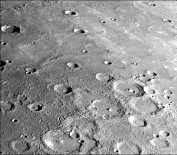 This photograph of Mercury was taken by NASA Mariner 10 spacecraft shows smooth plains areas on Mercury that are thought to be volcanic in origin with lava flows filling in heavily cratered areas.