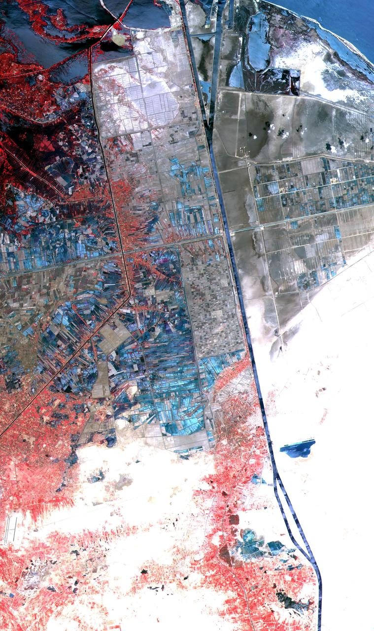 One of the most important waterways in the world, the Suez Canal runs north to south across the Isthmus of Suez in northeastern Egypt. This image of the canal covers an area 36 kilometers (22 miles) wide and 60 kilometers (47 miles) long in three bands of the reflected visible and infrared wavelength region. It shows the northern part of the canal, with the Mediterranean Sea just visible in the upper right corner. The Suez Canal connects the Mediterranean Sea with the Gulf of Suez, an arm of the Red Sea. The artificial canal provides an important shortcut for ships operating between both European and American ports and ports located in southern Asia, eastern Africa, and Oceania. With a length of about 195 kilometers (121 miles) and a minimum channel width of 60 meters (197 feet), the Suez Canal is able to accommodate ships as large as 150,000 tons fully loaded. Because no locks interrupt traffic on this sea level waterway, the transit time only averages about 15 hours. ASTER acquired this scene on May 19, 2000.  http://photojournal.jpl.nasa.gov/catalog/PIA02661