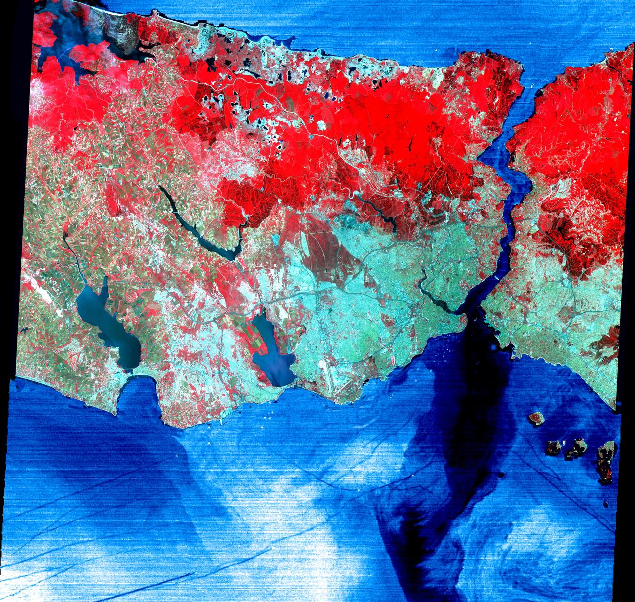 This June 16, 2000 image of Istanbul, Turkey show a full 60 by 60 km ASTER scene in the visible and infrared channels. Vegetation appears red, and urban areas blue-green. Bustling Istanbul, with its magnificent historical heritage, has spanned the divide between Europe and Asia for more than 2,500 years. Originally called Byzantium, the city was founded in the 7th century BC on the Golden Horn, an arm of the narrow Bosporus (also spelled Bosphorus) Strait, which connects the Sea of Marmara to the south, with the Black Sea to the north. Constantine I made it his capital of the Eastern Roman Empire in AD 330. As Constantinople, the strategically located city arose as the preeminent cultural, religious, and political center of the Western world. It reached the height of its wealth and glory in the early 5th century. After centuries of decline, the city entered another period of tremendous growth and prosperity when, as Istanbul, it became the capital of the Turkish Ottoman Empire in 1457. Although Turkey moved its capital to Ankara in 1923, Istanbul remains the nation's largest city with a population of over 8 million, its commercial center, and a major port. Two bridges spanning the Bosporus, and ships in the busy channel can be seen on the enlargement. On the image, the water areas have been replaced with a thermal image: colder waters are displayed in dark blue, warmer areas in light blue. Note the dark lines showing boat wakes, and the cold water entering the Sea of Marmara from deeper waters of the Bosporus.  http://photojournal.jpl.nasa.gov/catalog/PIA02665