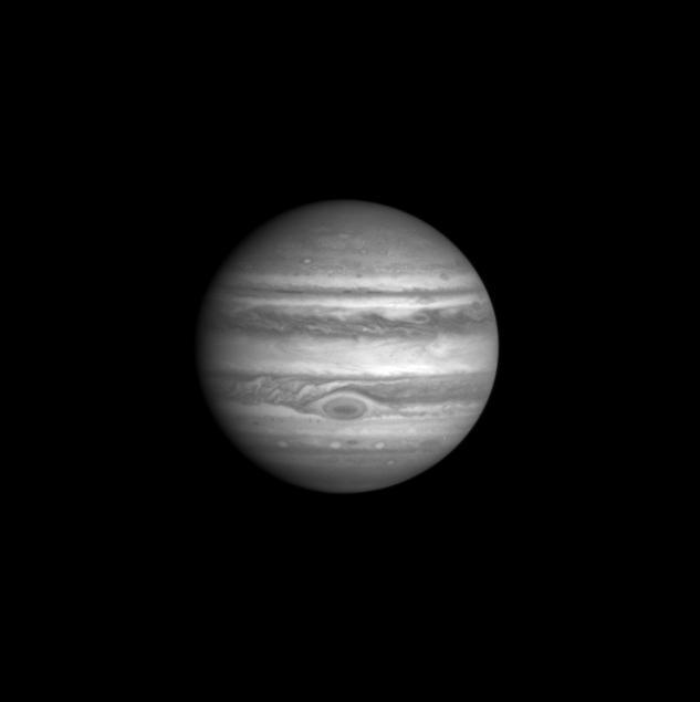 This image of Jupiter was taken by the Cassini Imaging Science narrow angle camera through the blue filter (centered at 445 nanometers) on October 1, 2000, 15:26 UTC at a distance of 84.1million km from Jupiter. The smallest features that can be seen are 500 kilometers across. The contrast between bright and dark features in this region of the spectrum is determined by the different light absorbing properties of the particles composing Jupiter's clouds. Ammonia ice particles are white, reflecting all light that falls on them. But some particles are red, and absorb mostly blue light. The composition of these red particles and the processes which determine their distribution are two of the long-standing mysteries of Jovian meteorology and chemistry. Note that the Great Red Spot contains a dark core of absorbing particles.   http://photojournal.jpl.nasa.gov/catalog/PIA02666