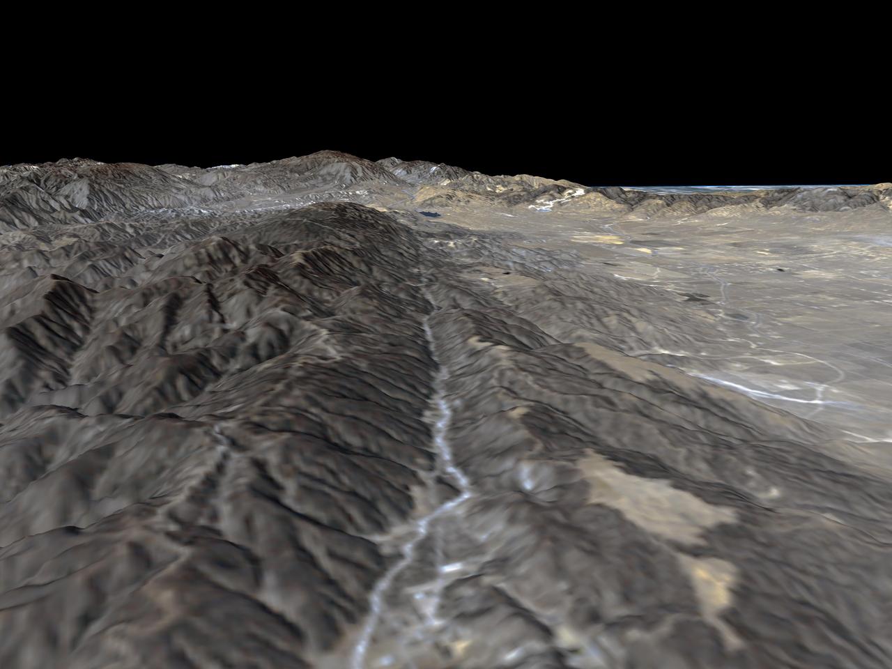 The prominent linear feature straight down the center of this perspective view is California famous San Andreas Fault. The image was created with data from NASA Shuttle Radar Topography Mission SRTM.