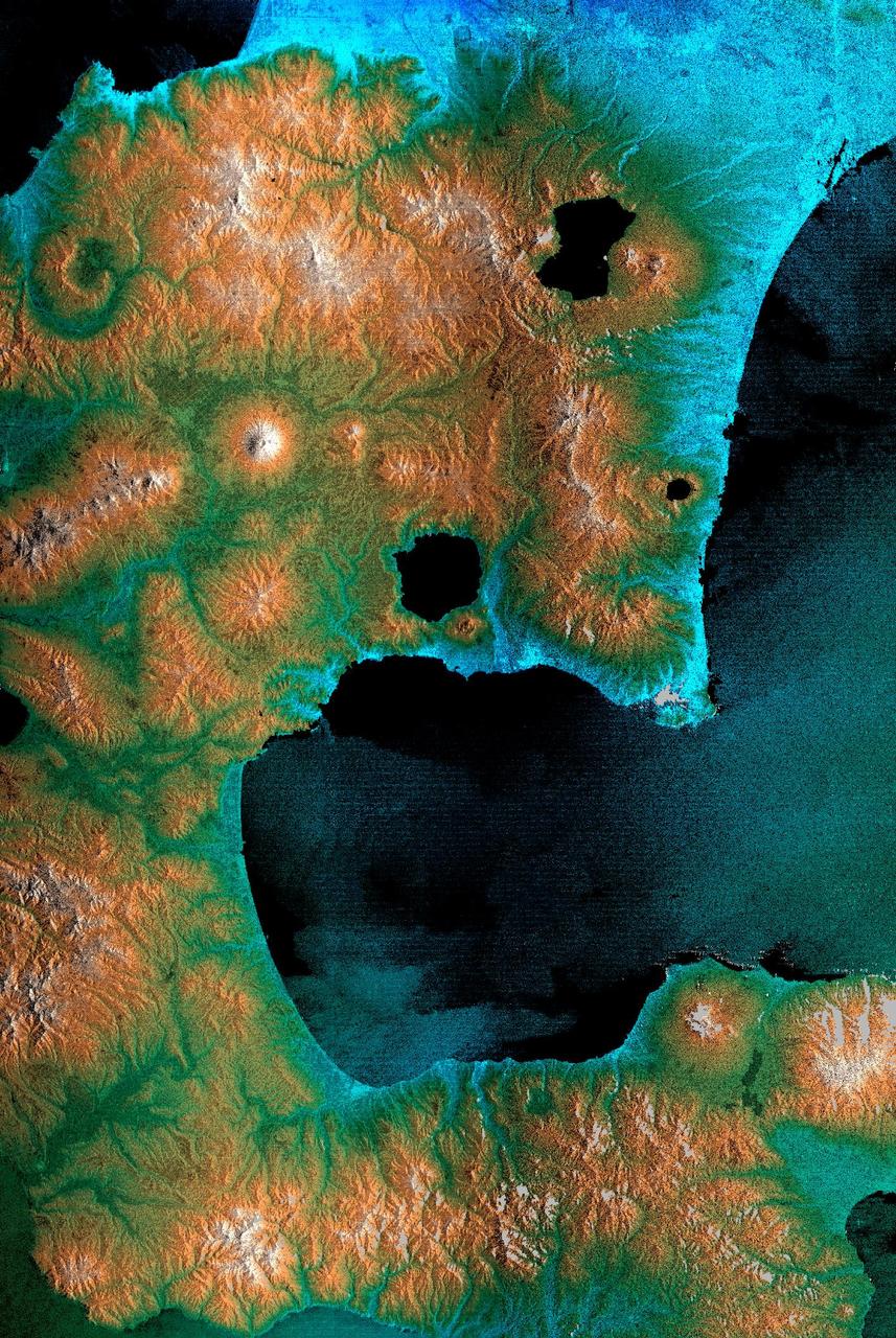 The southeast part of the island of Hokkaido, Japan, is an area dominated by volcanoes and volcanic caldera. The active Usu Volcano is at the lower right edge of the circular Lake Toya-Ko and near the center of the image.