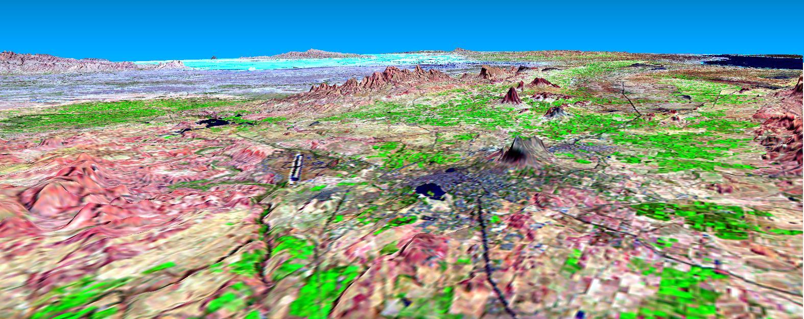 This perspective view shows the city of Bhuj, India, in the foreground gray area after an earthquake in western India on January 26, 2001. This image was generated from NASA Landsat satellite and data from Shuttle Radar Topography Mission SRTM.