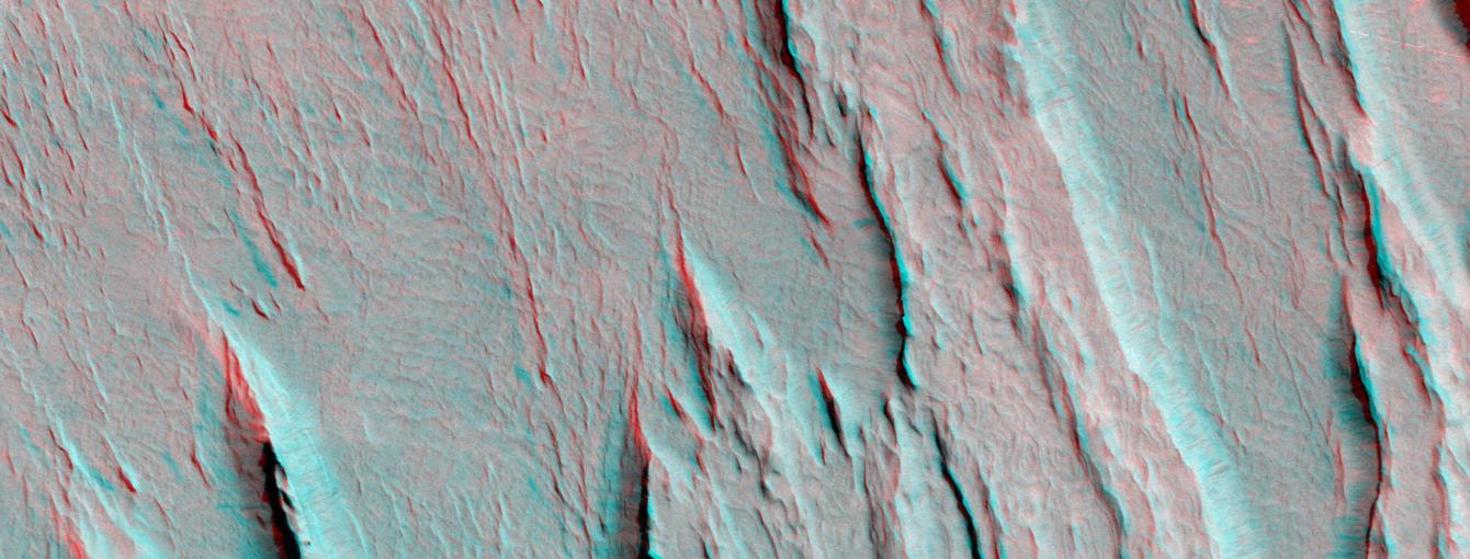 Layers of bedrock etched by wind to form sharp, elongated ridges known to geomorphologists as yardangs are commonplace in the southern Elysium Planitia/southern Amazonis region of Mars. 3D glasses are necessary to view this image.