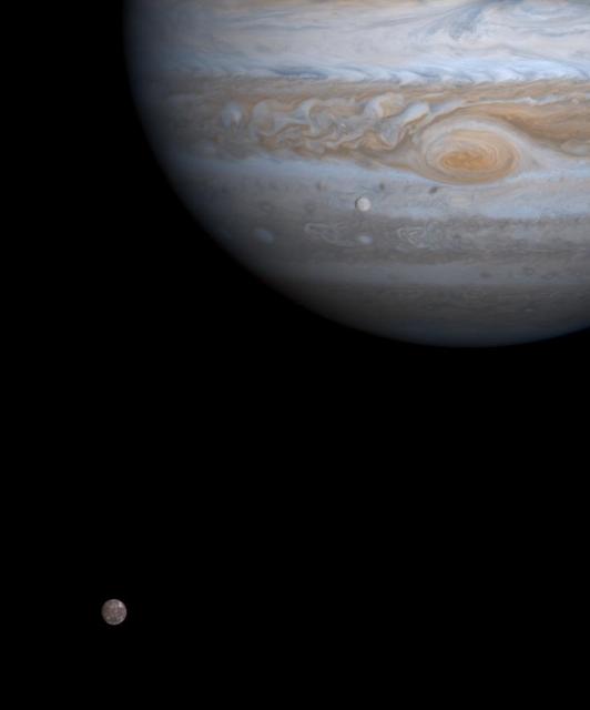 One moment in an ancient, orbital dance is caught in this color picture taken by NASA Cassini spacecraft on Dec. 7, 2000, just as two of Jupiter four major moons, Europa and Callisto, were nearly perfectly aligned with each other.