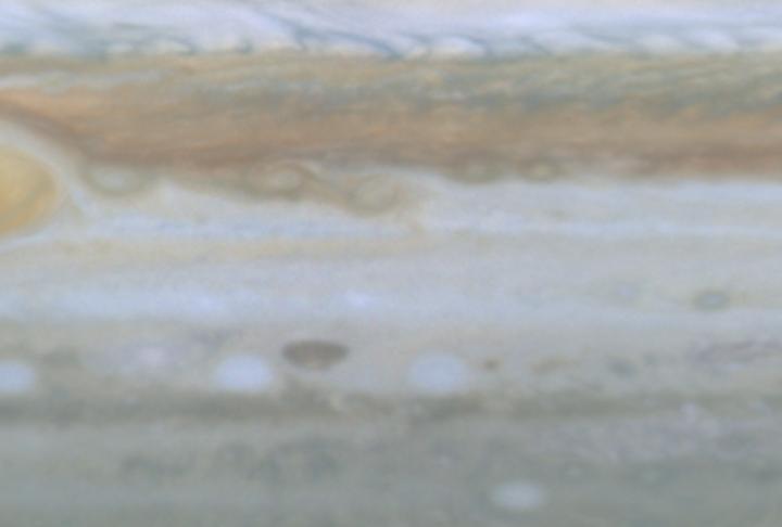 This image is a still frame, created from images taken by NASA Cassini spacecraft, shows small spots slipping over each other east of Jupiter Great Red Spot. 