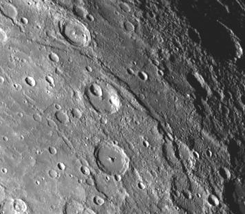 A scarp, or cliff, extends diagonally from upper left to lower right in this picture of Mercury taken by NASA Mariner 10. The structures are believed to be formed by the compressive forces due to crustal shortening.