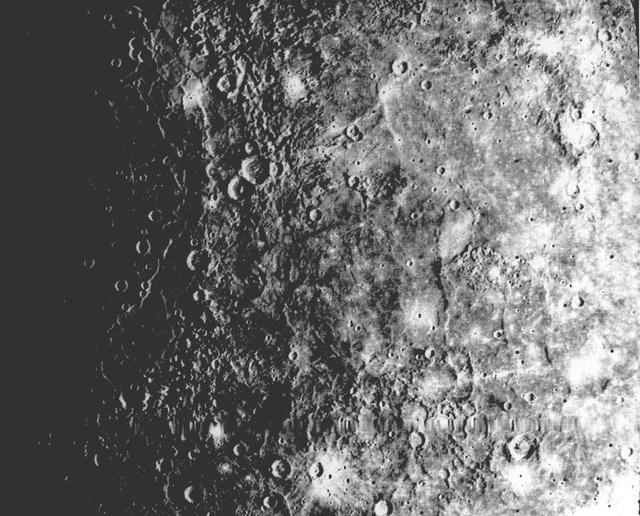 NASA Mariner 10 shows a close-up view of one-half of a circular basin the largest observed on Mercury. Hills and valleys extend in a radial fashion outward from the main ring.  