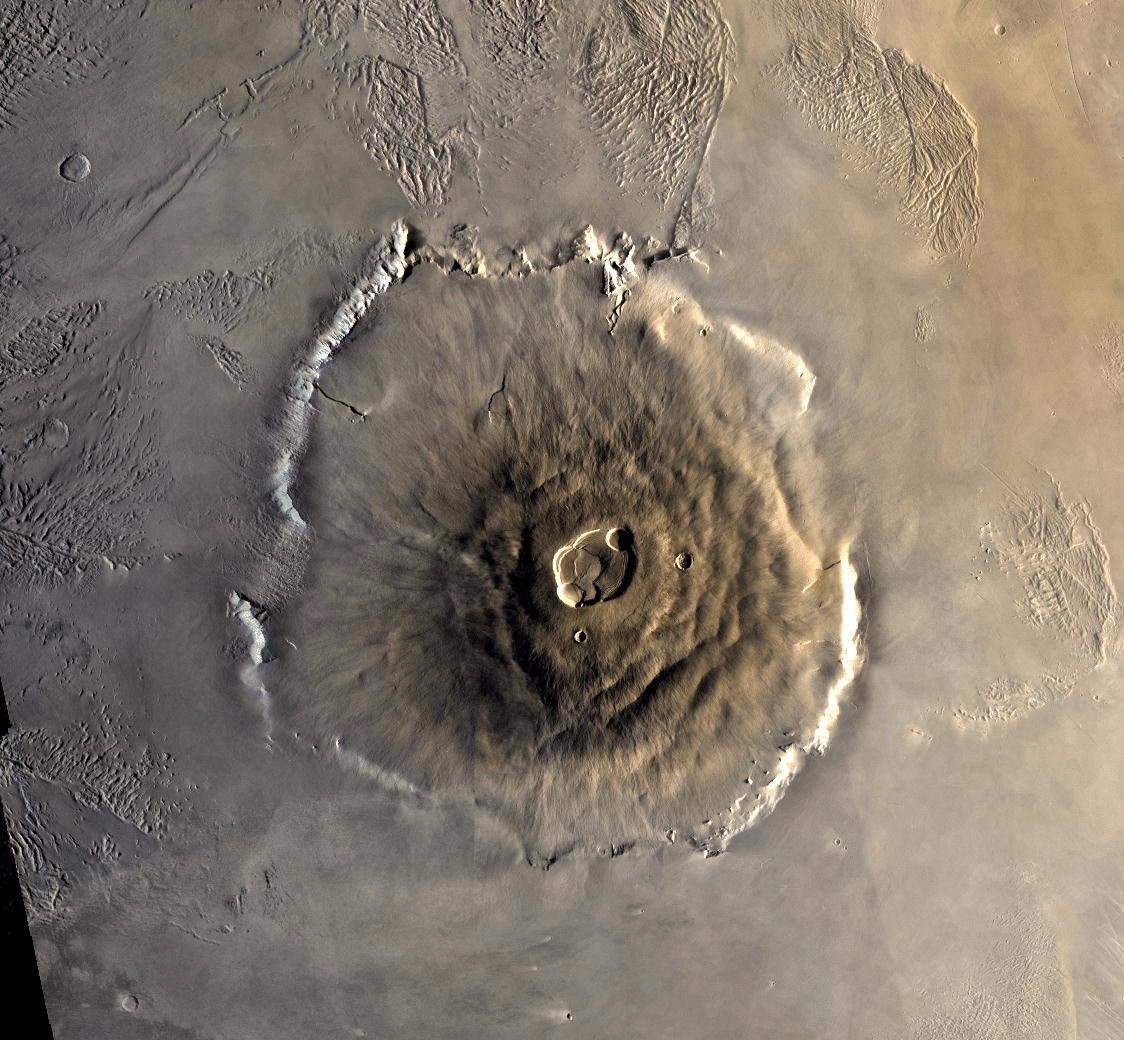 Color mosaic of Olympus Mons volcano on Mars from the Viking 1 Orbiter. The mosaic was created using images from orbit 735 taken 22 June 1978. Olympus Mons is about 600 km in diameter and the summit caldera is 24 km above the surrounding plains.