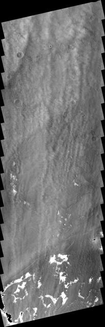 This image from NASA 2001 Mars Odyssey spacecraft shows a system of clouds just off the margin of the South Polar cap. Taken during the summer season, these clouds contain both water-ice and dust.